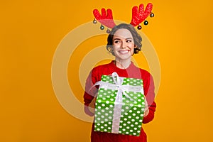 Photo of beautiful lady hold winter holiday big giftbox festive event party x-mas surprise look side glad wear deer