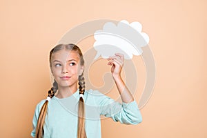 Photo of beautiful little lady holding white empty paper cloud deep thinking look empty space smart school girl wear