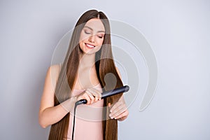 Photo of beautiful model lady long hairstyle hold electric styler curler making straight curls preparing romantic date