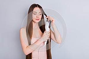 Photo of beautiful model lady long hairstyle hold electric styler curler making straight curls wavy watch result wear