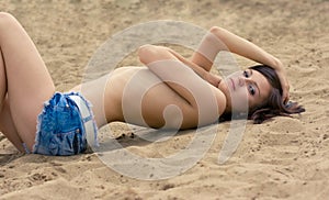 Photo of a beautiful model relaxing on a beach