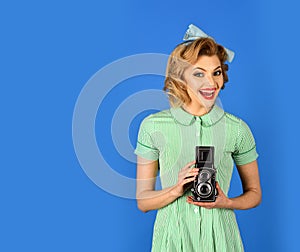 Photo of beautiful pin-up girl with old camera