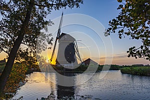 Photo during a beautiful sunset of an old windmill along the Kerkvaart near Hazerswoude Dorp, the Netherlands