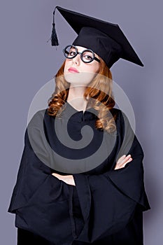 Photo of beautiful young alumnus in black suit on the wonderful