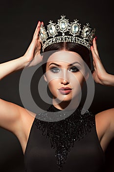 Photo of beautiful young girl in crown and black dress