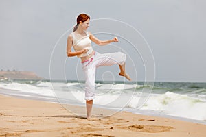Photo of beautiful young woman doing joga on the wonderful see a