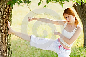 Photo of beautiful young woman doing joga on the wonderful trees