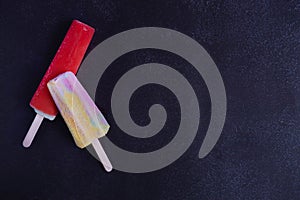 Photo of berry ice cream on a dark background. Dark photo of ice cream. Homemade cherry and strawberry ice cream