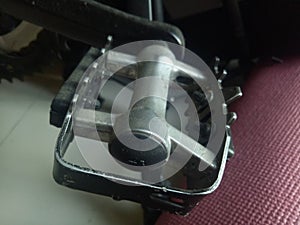 Photo of a bicycle pedal crank made of aluminum in black color