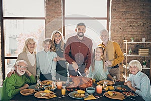 Photo of big family standing hugging feast table holiday roasted turkey making traditional portrait eight relatives