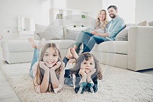 Photo of big family two children comfortable lying floor fluffy carpet while parents sit sofa