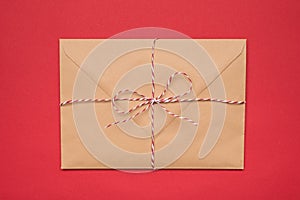 Photo of big package tied with striped red and white string ribbon isolated bright backdrop