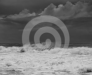 Photo of big waves along the Sunshine Coast under dark cloudy skies in Queensland, Australia