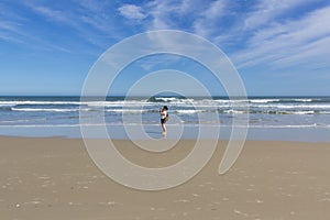 Girl standing on a beach in South Brazil