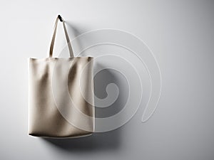 Photo black cotton textile bag hanging in left side. Empty white wall background. Highly detailed texture, space for