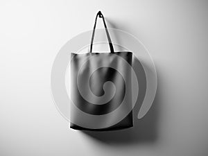 Photo black rubberized material bag hanging in center. Empty white wall background. Highly detailed texture, space for