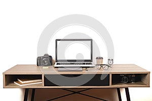 Photo blogger / photographer / it specialist`s typical office space table with laptop, blank screen, coffee cup and electronics.