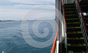 photo of blue sea view and ship deck stairs