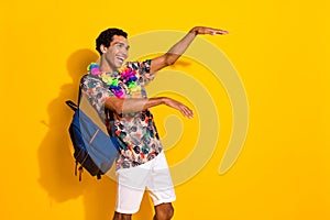 Photo of boogie woogie party guy t shirt has chill vibe dance in hawaiian necklace and backpack isolated over yellow