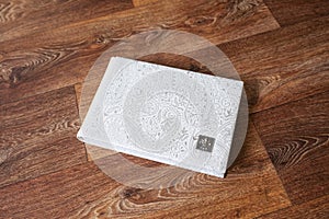 Photo book with a cover of genuine leather. White color with decorative stamping