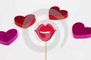 Photo booth props lips against blurred hearts on white background