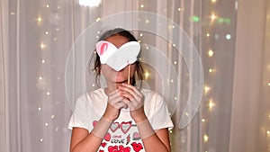 Photo booth  shape of heart close up in hands of llittle dark hair smiling girl on Valentines Day. Slow motion.