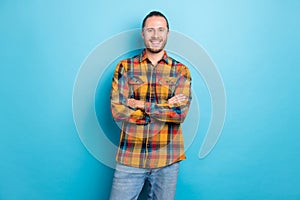 Photo of boss millennial brunette guy crossed arms wear checkered shirt isolated on blue color background