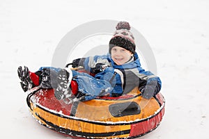 Photo of boy on tubing in winter park