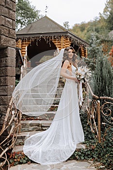 Photo of the bride in full height on elegant steps