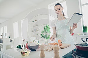 Photo of broody concentrated woman counting amount of sliced pieces of pepper trying to calculate their weight