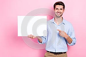 Photo of brunet hair young handsome smiling man wear casual shirt indicate empty space placard new brand company