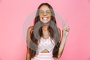 Photo of brunette woman 20s wearing sunglasses laughing and show