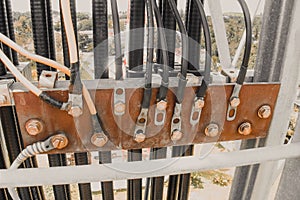 Photo of a busbar that has cable and ground wire connected.