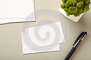 Photo of business cards stack with pen on grey background. Template for branding identity