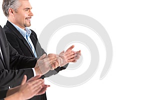 Photo of business people applauding at white background.