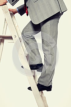 Photo of Businessman climbing ladder