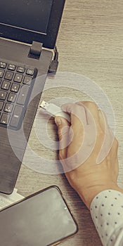 Businessman hand using his usb flash drive, close-up. Office work.