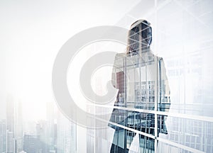 Photo of businesswoman. Double exposure, city on the background. Blurred background, horizontal