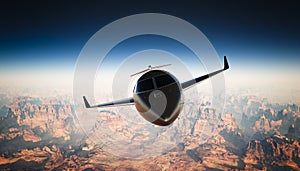 Photo Cabin Black Matte Luxury Generic Design Private Jet Flying in Sky under Earth Surface. Grand Canyon Background
