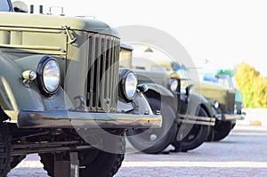 Photo of the cabins of three military off-road vehicles from the times of the Soviet Union. Side view of military cars from the f