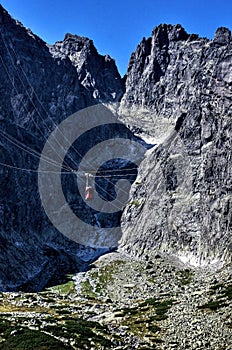 Photo of cable lift against the sky and Lomnicky Stit