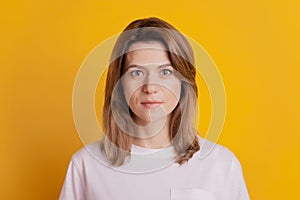 Photo of calm focused dream lady look camera wear casual outfit on yellow background