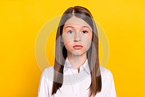 Photo of calm focused serious cute schoolgirl look camera wear white shirt isolated yellow color background