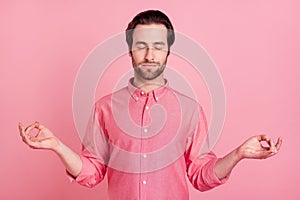 Photo of calm peaceful young man make fingers om sign asana rest isolated on pastel pink color background