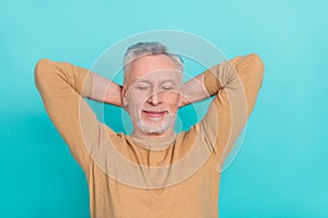 Photo of calm positive person arms behind head closed eyes drowse isolated on turquoise color background