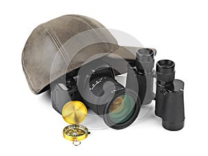 Photo camera, compass, binoculars and cap