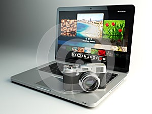 Photo camera and laptop with image viewer on the screen. Digital