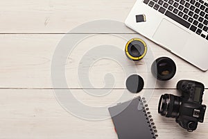 Photo camera, lens and memory card at computer