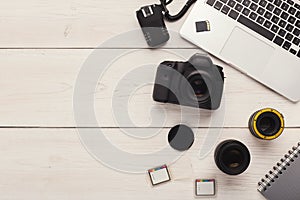 Photo camera, lens and memory card at computer