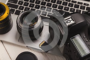 Photo camera lenses and memory card on computer